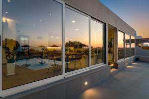 a balcony with a view of a table and chairs at En Plo Boutique Suites in Oia