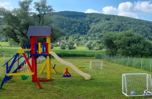 a playground with a slide in the grass at Una Luxury Home in Bihać