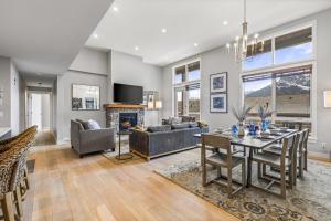 a living room with a table and a fireplace at BRAND NEW - Gorgeous Spring Creek Penthouse in Canmore