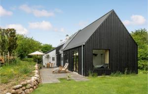 a black house with a black roof at Stunning Home In Knebel With House A Panoramic View in Knebel