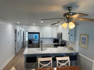 a kitchen with a large island with a ceiling fan at Boston Commons 102 Condo in Myrtle Beach