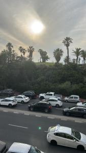 a bunch of cars parked in a parking lot at Apartment near Hilton in Tel Aviv