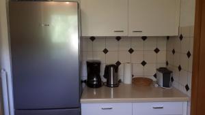 a kitchen with a refrigerator and a counter top at Ferienhäusle Sonnenblume Titisee in Titisee-Neustadt