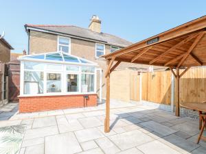 a patio with a conservatory and a wooden roof at Donnys Plaice in Great Yarmouth