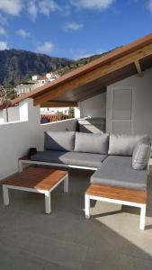 a patio with two couches and a coffee table at Central House at Tejeda's Heart with Amazing View in Tejeda