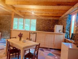 a dining room with a wooden table and chairs at Hotel Arkhoti in Akhieli +34 photos