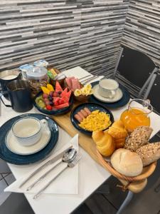 a table topped with plates and bowls of breakfast foods at A Tendinha - Guest House in Peso da Régua