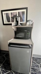 a microwave sitting on top of a refrigerator at La Quinta by Wyndham Big Spring in Big Spring