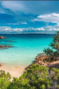 a view of a beach with blue water at Villa Alberto in Olbia