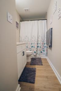 a bathroom with a toilet and a sink at City Retreat - 4 Bedroom Oasis with King & Private Yard near Downtown in Charlotte