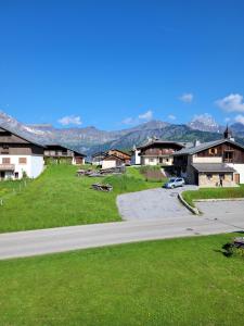 a road in a small village with houses and a car at Chalet Le Starfu in Crest-Voland
