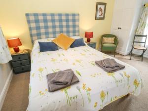 a bedroom with a bed with flowers on it at Middlehope Cottage in Bishop Auckland