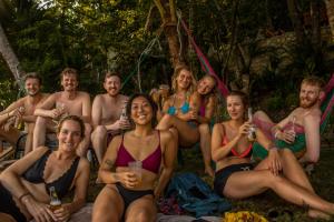 a group of people in bathing suits posing for a picture at Los Amigos Hostel in Flores