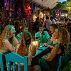 a group of people sitting in a restaurant at Los Amigos Hostel in Flores