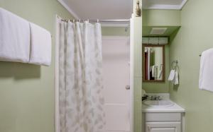 a bathroom with a shower curtain and a sink at Cute Manzanita Beach House MCA 749 - Meredith Lodging in Manzanita +33 photos