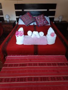 a bedroom with a bed with towels on it at HOSTAL LA PAZ in Antigua Guatemala