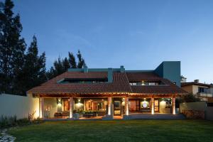 a house with a large yard in front of it at HOLT Balcones Guesthouse - King Bed Room in San Miguel de Allende