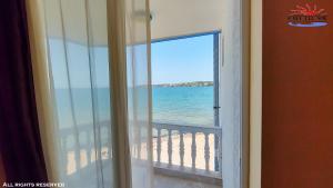a view of the beach from a window at CASA DEL SOL Sozopol in Sozopol