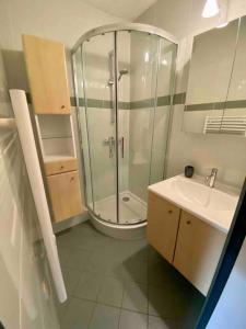 a bathroom with a glass shower and a sink at Studio 2/4 personnes - Centre village in La Clusaz