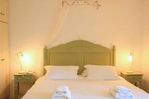 a bedroom with a bed with towels on it at Ambelas Mare Apartments in Ambelas