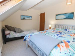 a bedroom with a bed and a staircase at Llwyn Celyn in Pwllheli