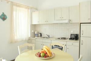 a kitchen with a plate of fruit on a table at Ambelas Mare Apartments in Ambelas