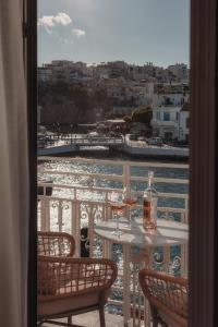 uma mesa com dois copos de vinho numa varanda em Luxury Suites by Lato em Agios Nikolaos