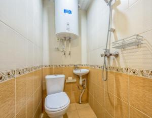 a small bathroom with a toilet and a sink at WonderHostel on Nevsky in Saint Petersburg