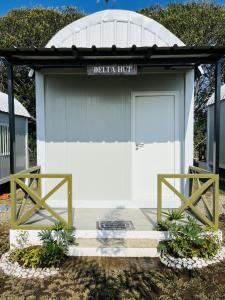 a garage with a white door and a sign on it at Camp Palo Bandera in Calatagan