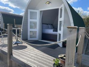 a bed in a dome tent on a deck at Glamping Pod with ensuite WC Near Kingsbridge & Salcombe in Kingsbridge