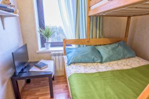 a small bedroom with a bunk bed and a desk at WonderHostel on Nevsky in Saint Petersburg