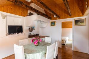 a dining room with a table and chairs and a television at Old Town Baroque Palace Accommodation in Dubrovnik