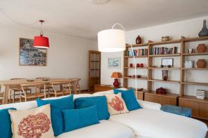 a living room with a white couch and a table at The Flat in Ericeira
