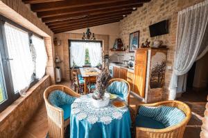 a dining room with a table and chairs and a kitchen at Moraio in Collazzone