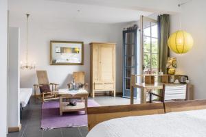 a bedroom with a bed and a table and a desk at Estrela do Atlântico in Horta