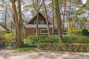 a brick house with trees in front of it at Haus Eva Mar am Meer Appartement 5 in Timmendorfer Strand