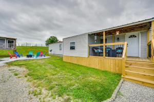 a home with a fence and chairs in the yard at Kentucky Vacation Rental Half-Mi to Mammoth Cave! in Sloans Crossing