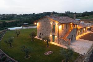 an aerial view of a stone house with lights at Villa meraviglia in Collazzone