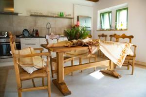a kitchen with a wooden table and some chairs at Villa meraviglia in Collazzone