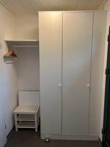 a closet with white cabinets and a bench in a room at Alte Küsterei Hohen Mistorf in Hohen Mistorf