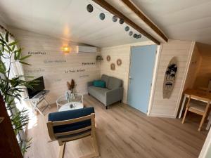 a small living room with a couch and a table at Maison MAHECO in Gujan-Mestras
