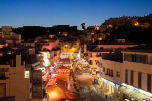 a view of a city street at night at Hotel Baltum in Albufeira