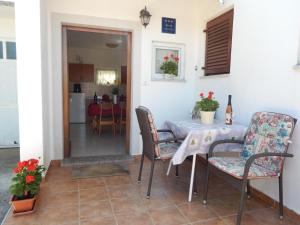 a dining room with a table and chairs at Apartment Štrmac in Labin
