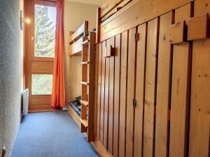 a room with wooden walls and a window at Appartement Les Arcs 1800, 2 pièces, 5 personnes - FR-1-346-484 in Arc 1800