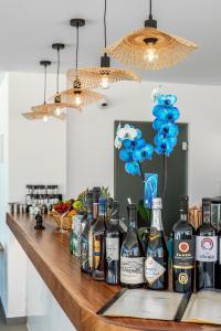 a bar with bottles of alcohol on a counter at En Plo Boutique Suites in Oia