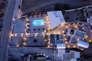 an aerial view of a building with lights on it at En Plo Boutique Suites in Oia