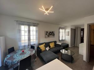 a living room with a couch and a table at Appartement pour 2 personnes en ville avec terrasse in La Londe-les-Maures +23 photos