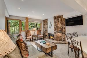 a living room with a couch and a fireplace at Laurelwood Condominiums 303 in Snowmass Village