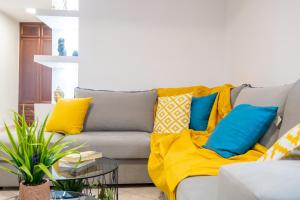 a living room with a couch with colorful pillows at Seaside Guesthouse in Kavala