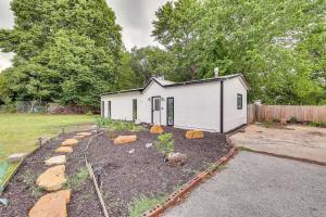 a small white shed with a garden in a yard at Springdale Vacation Rental about 9 Mi to Fayetteville! in Springdale